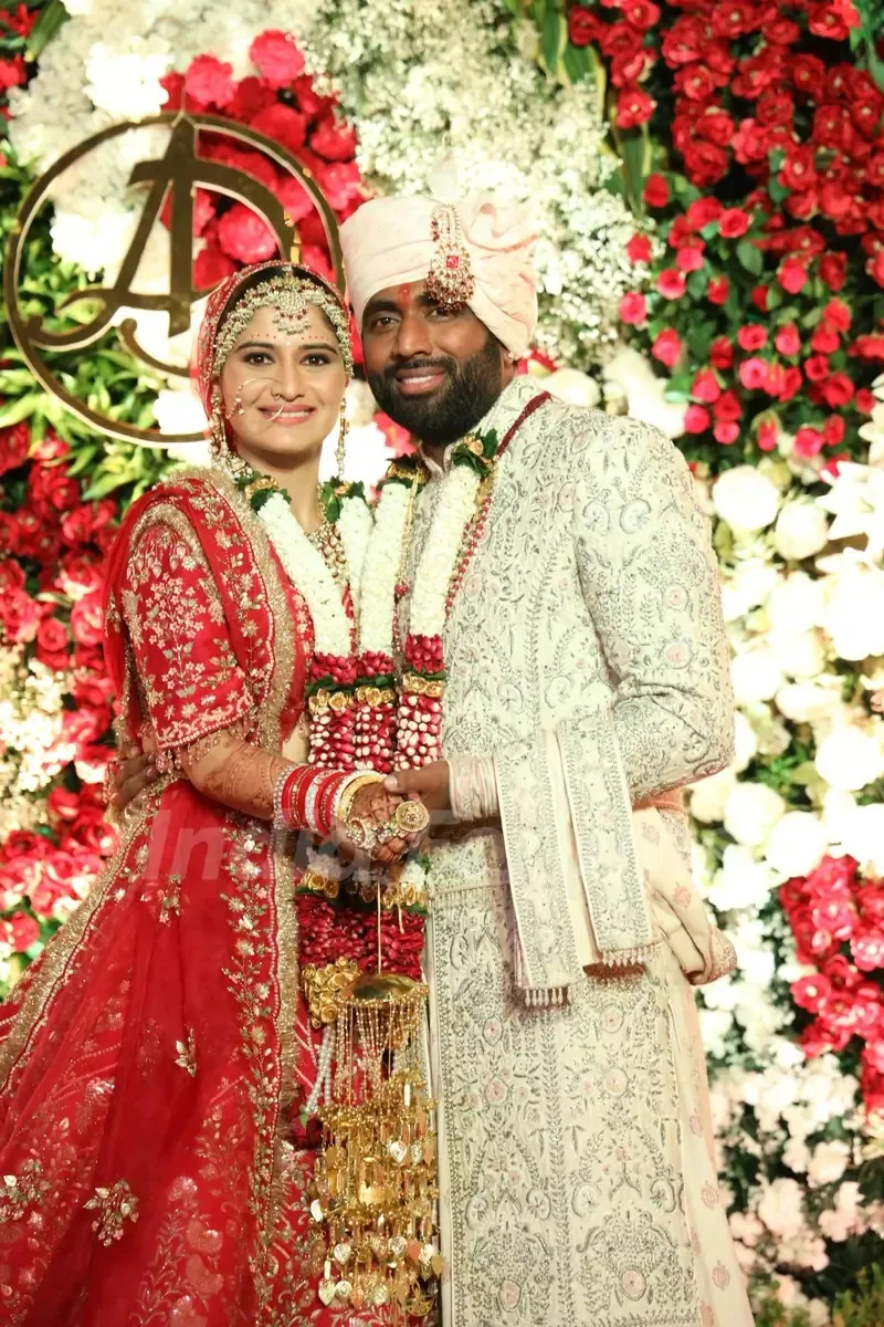 Arti Singh with her groom in a traditional wedding attire