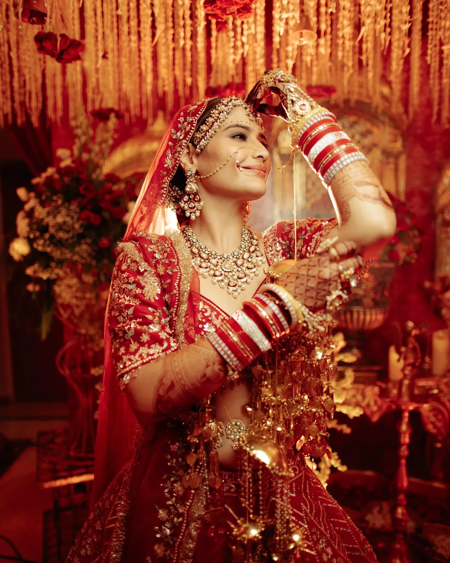 Arti Singh dancing joyfully in her beautiful red bridal wear