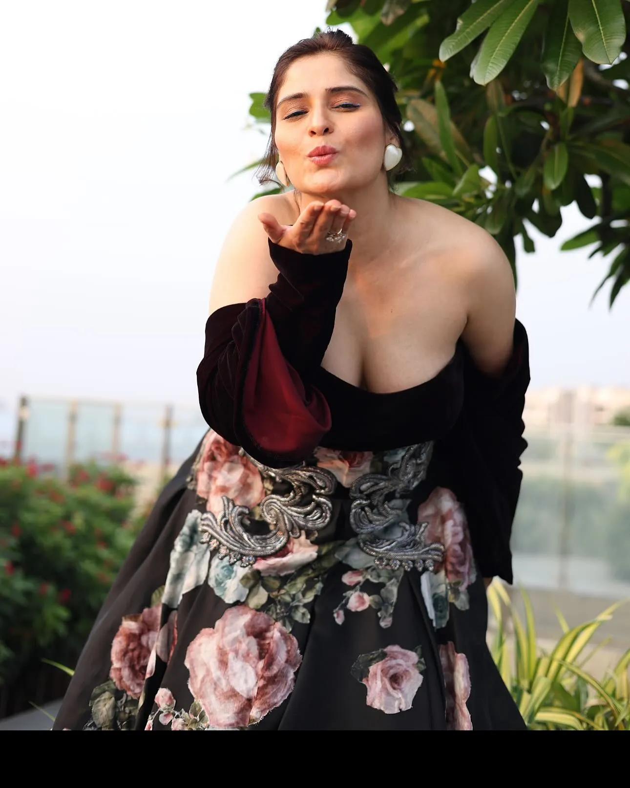 Arti Singh posing gracefully in an off shoulder floral dress