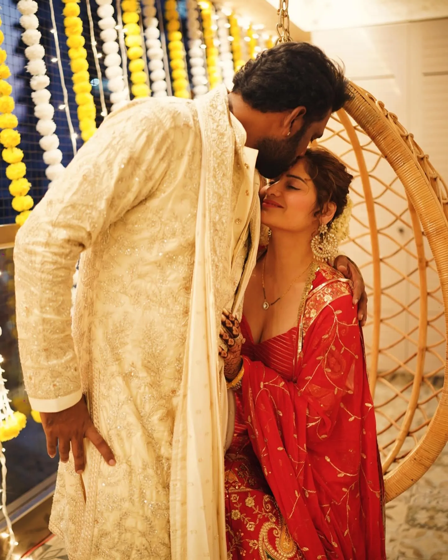 Arti Singh and groom pose beside the floral wedding setup