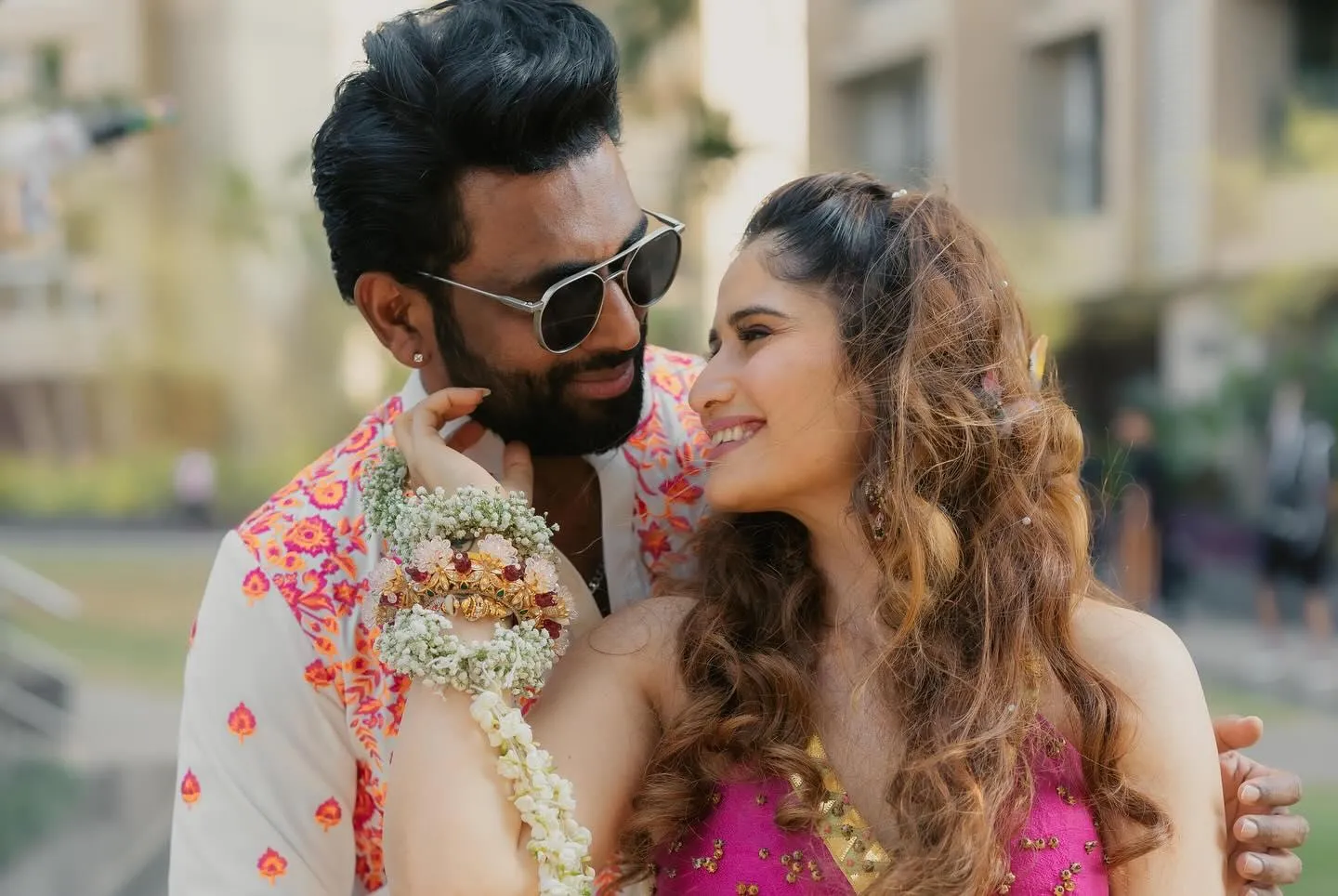 Arti Singh and groom pose romantically in a daylight setting