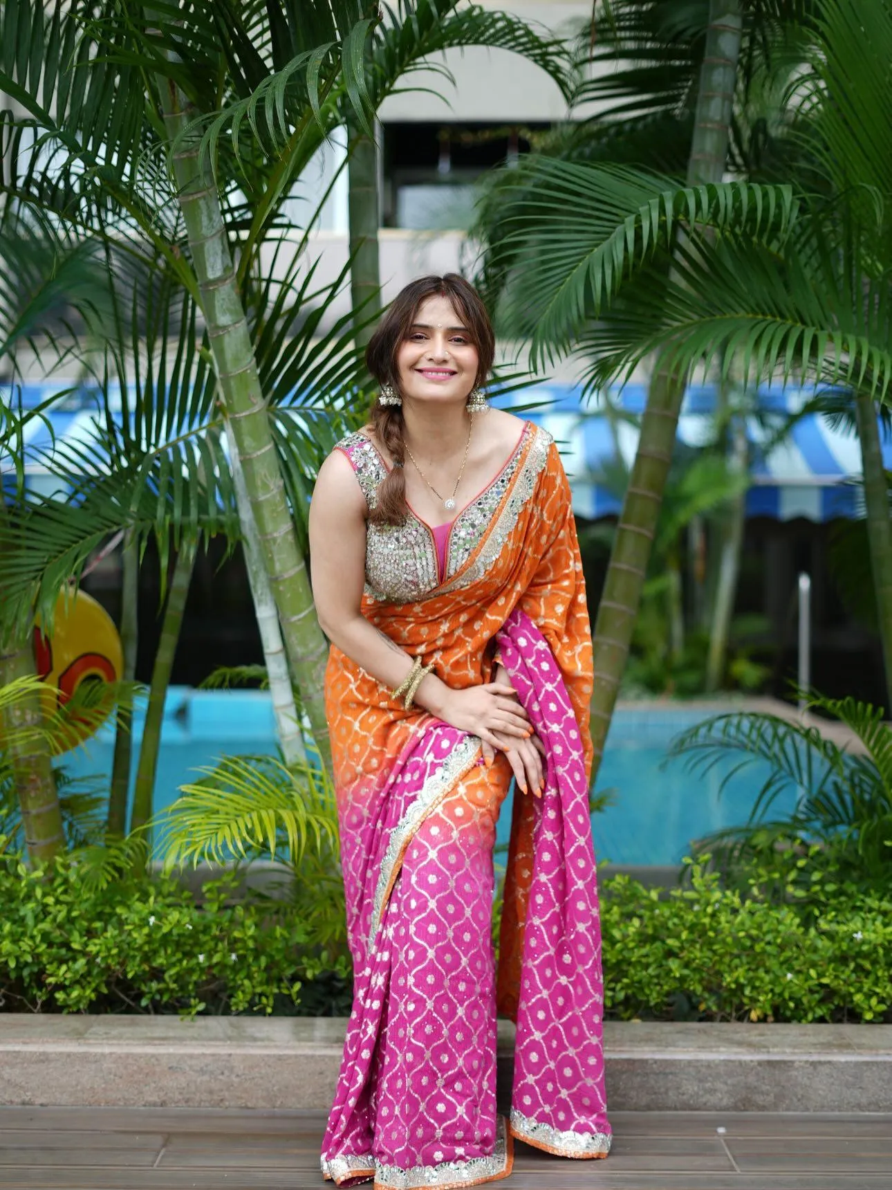 Arti Singh beams in pink lehenga with bright orange dupatta