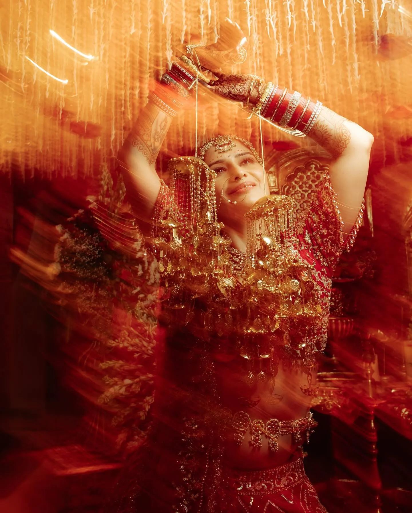 Arti Singh dances in a blurred motion wearing festive red