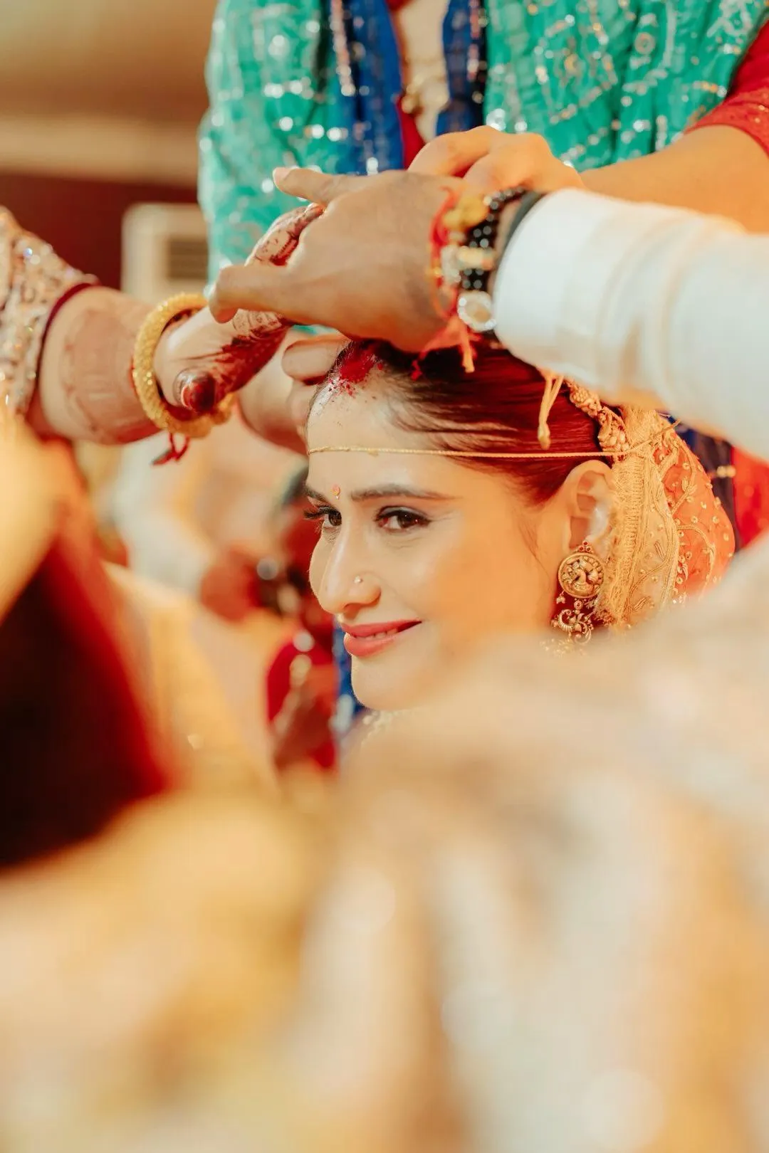 Arti Singh during a wedding ritual in bridal red attire