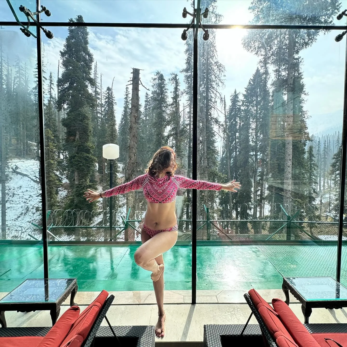 Arti Singh enjoys a poolside view in pink swimwear wallpaper