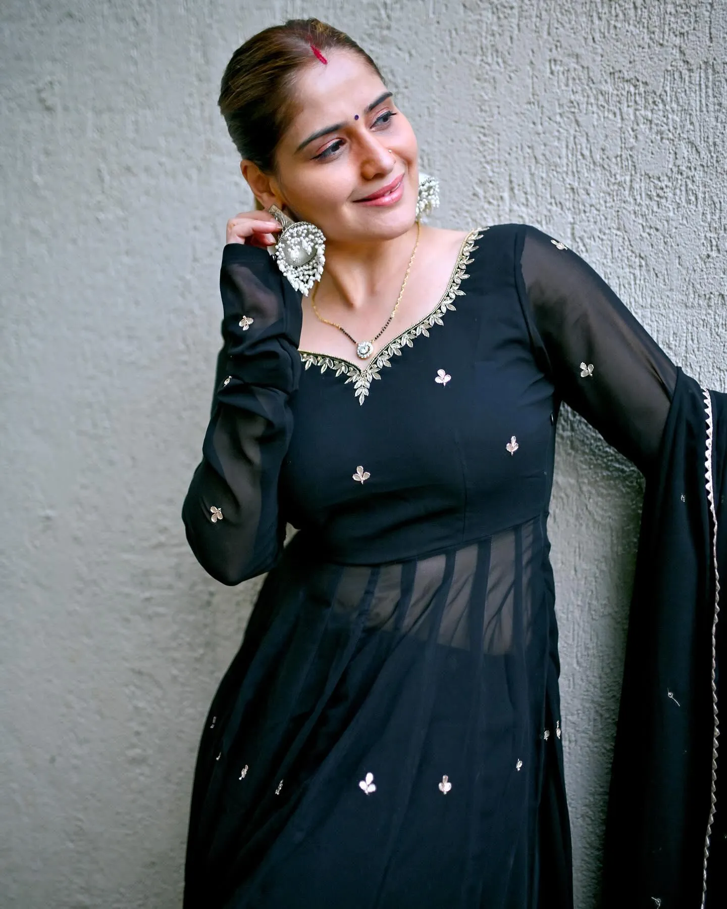 Arti Singh gives a shy smile in a netted black gown look