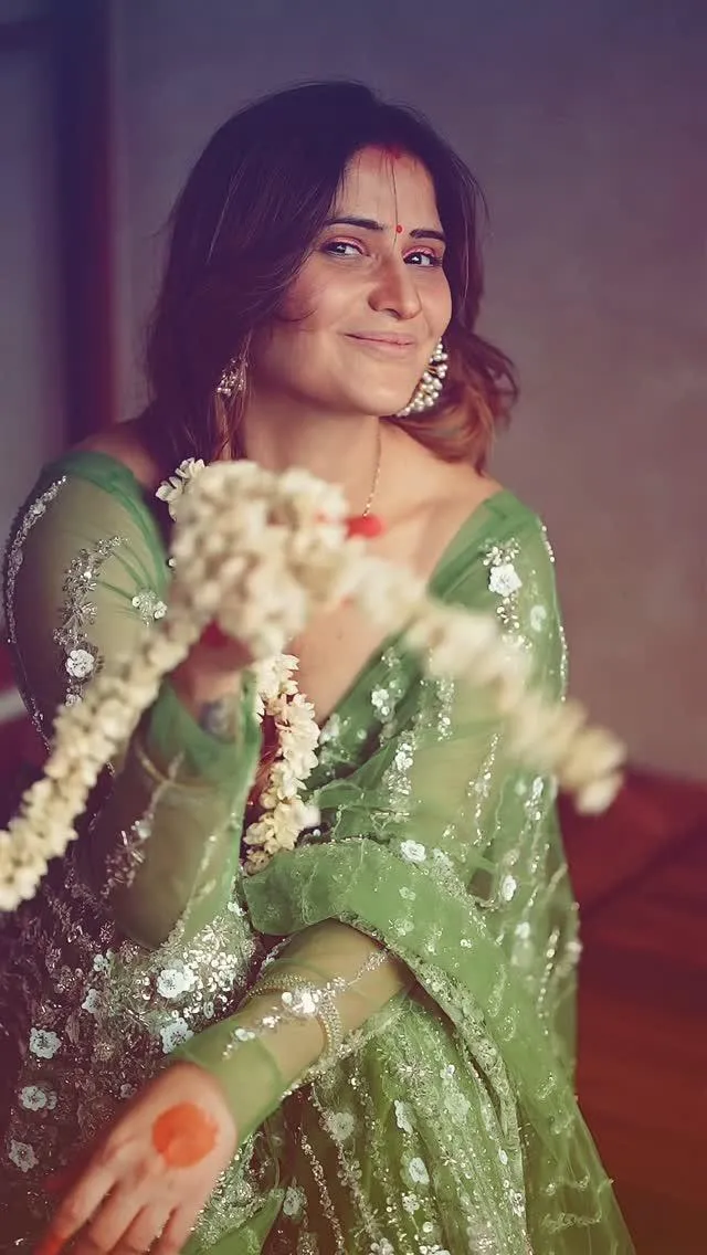 Arti Singh glows in a green embellished saree and earrings