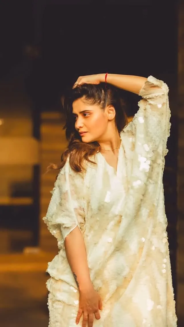 Arti Singh glows in a soft white dress under warm lights