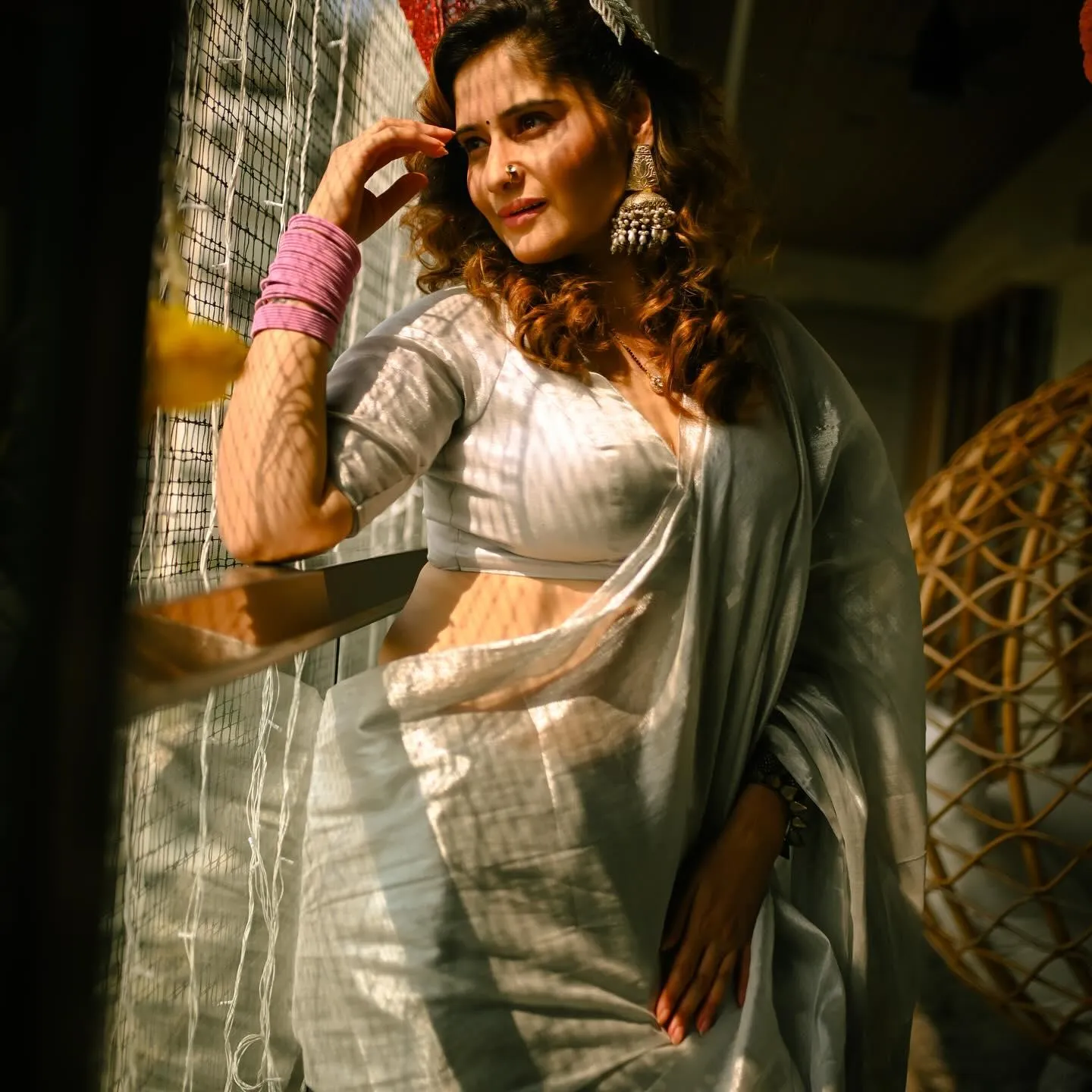 Arti Singh glows in a white sheer saree under warm lights