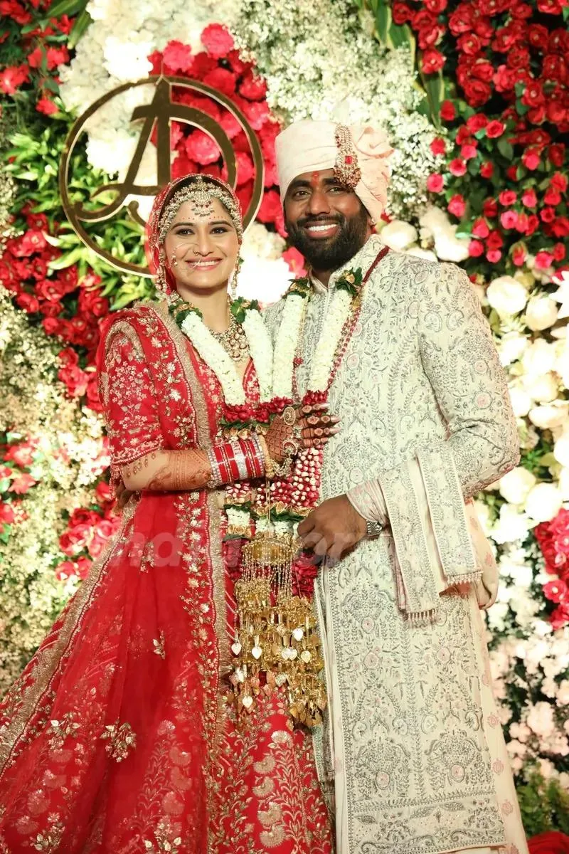 Arti Singh in bridal red smiling with groom on wedding day