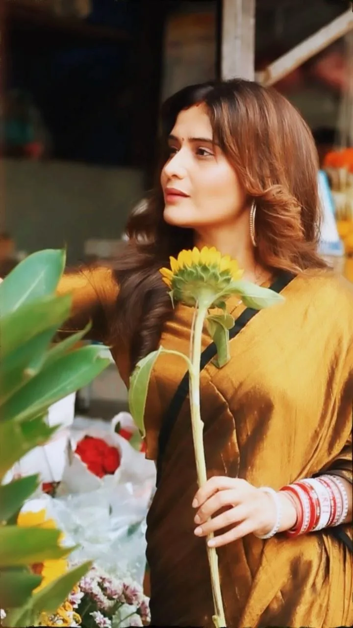 Arti Singh in mustard dress enjoying a peaceful garden walk