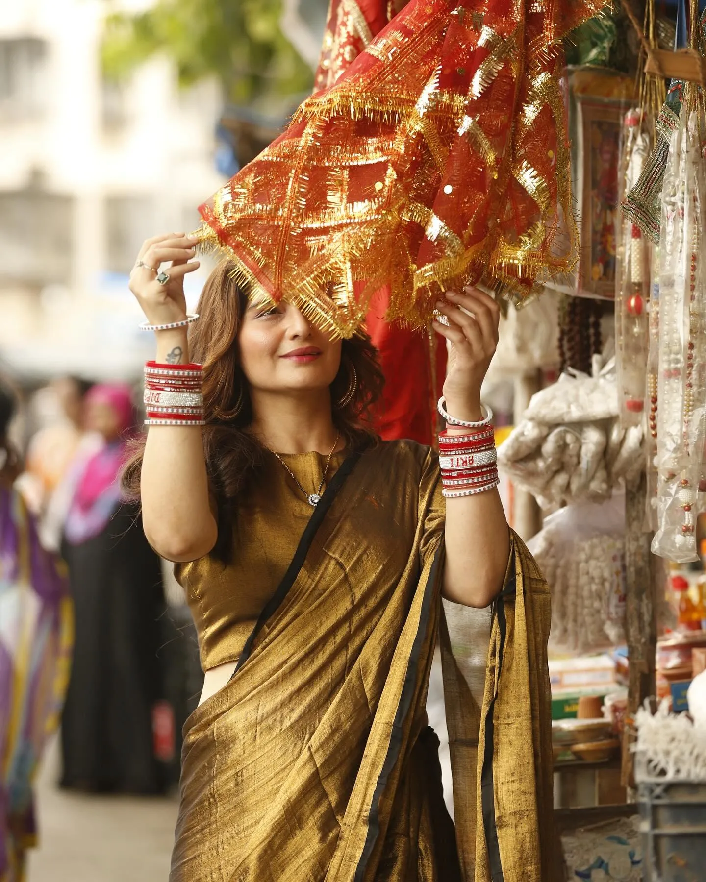 Arti Singh in traditional attire holding a decorative dress