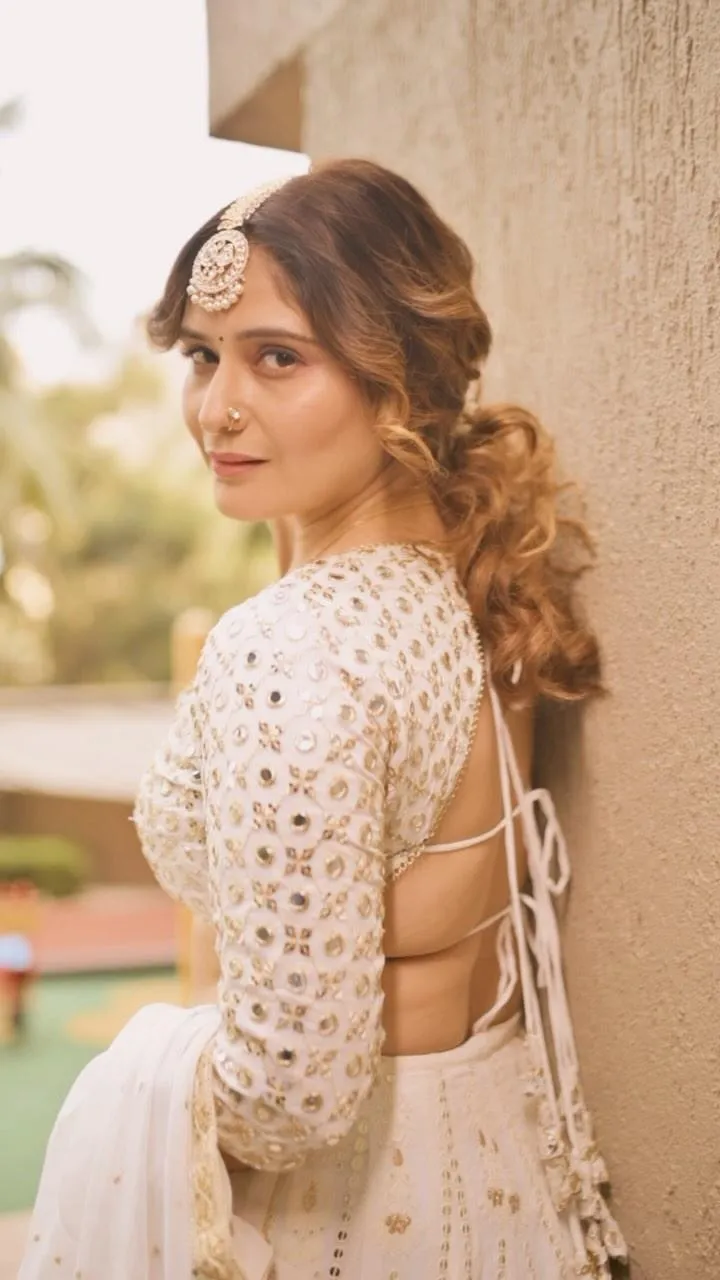 Arti Singh in white dress posing outdoors with natural light