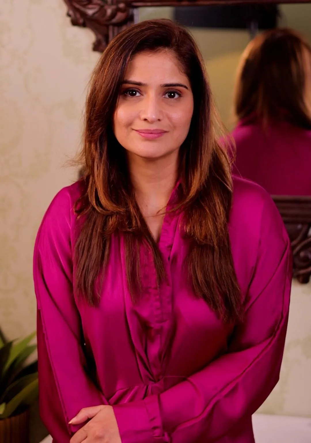 Arti Singh poses in a bold magenta outfit with a soft smile