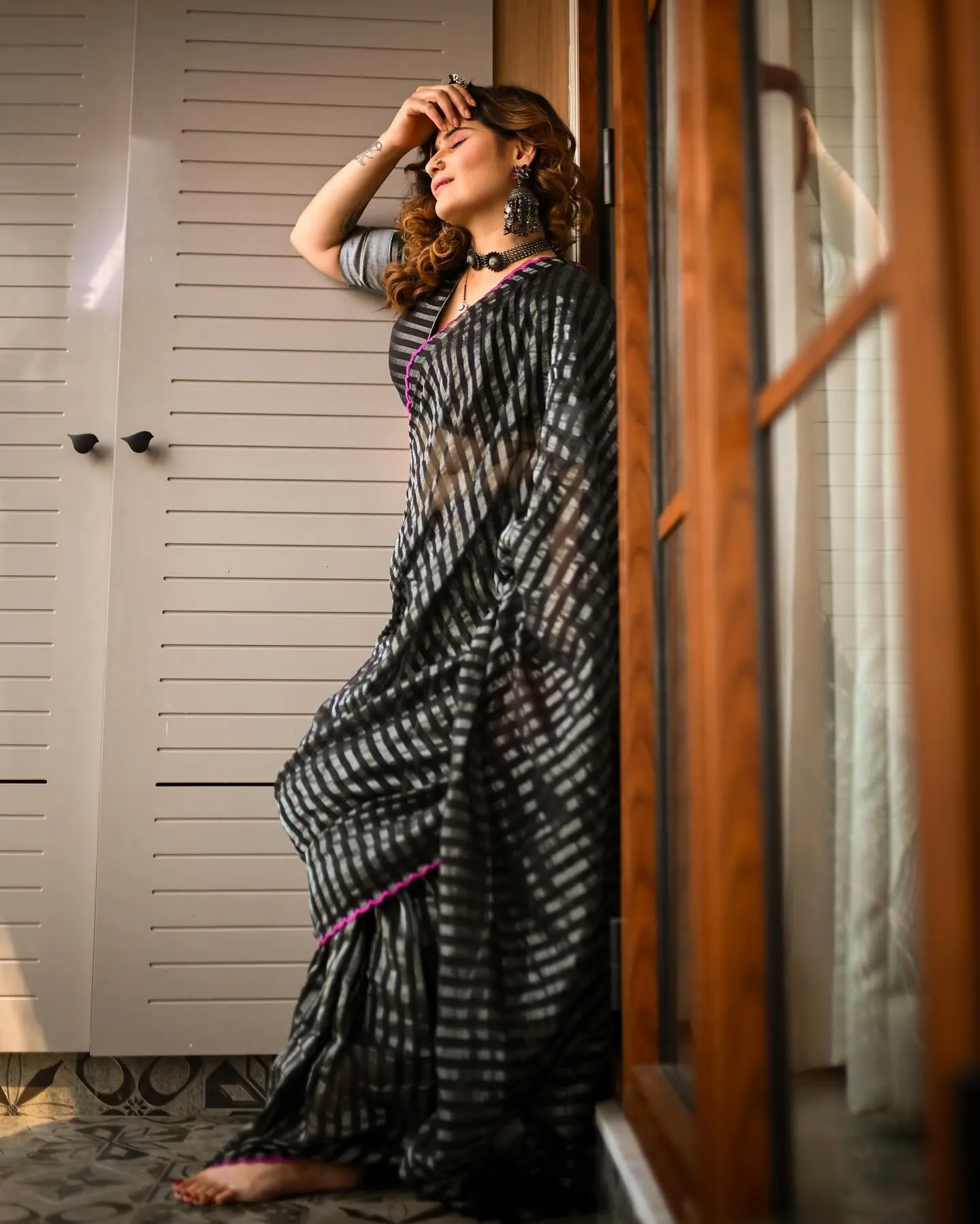 Arti Singh poses in a graceful black and silver saree image