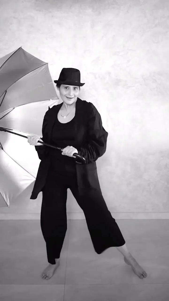 Arti Singh poses in black outfit with hat in a dance studio