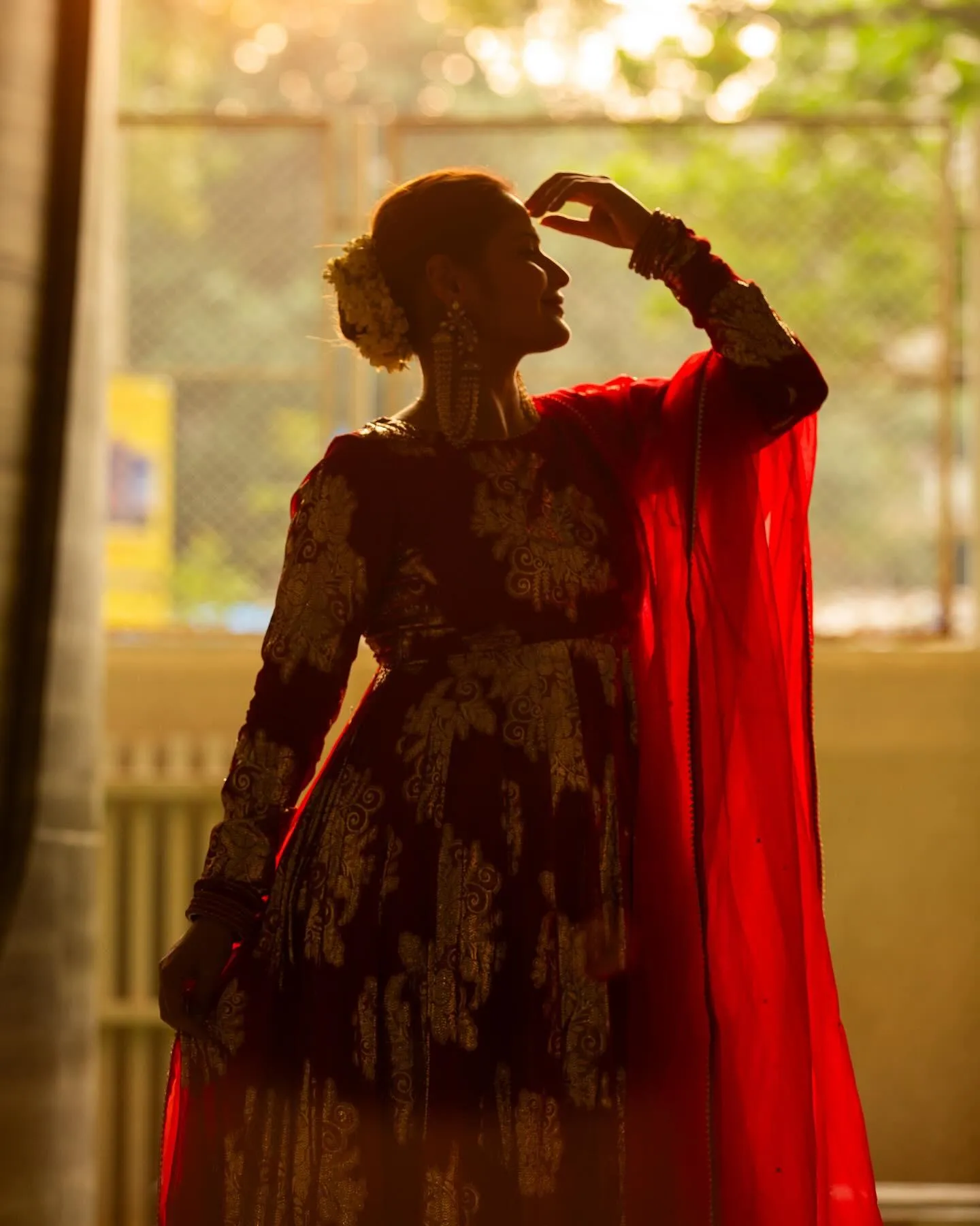 Arti Singh poses in red gown with backlight and shadow play