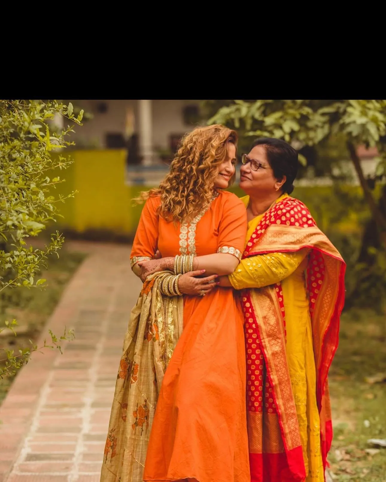 Arti Singh shares a happy moment in an orange wedding dress