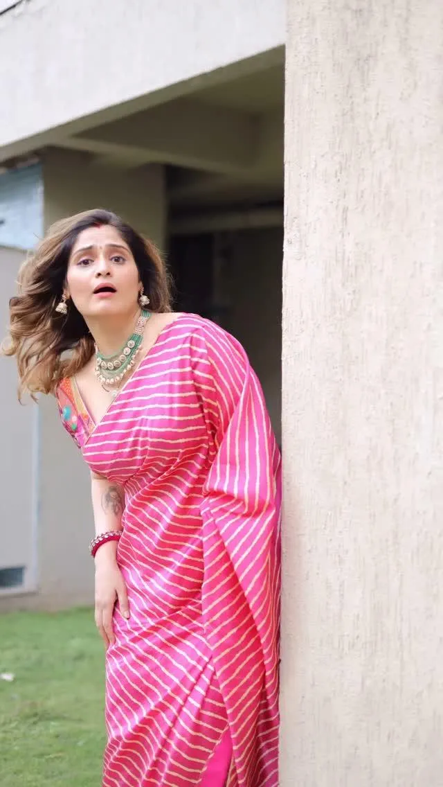 Arti Singh smiles in a bright pink suit in casual elegance