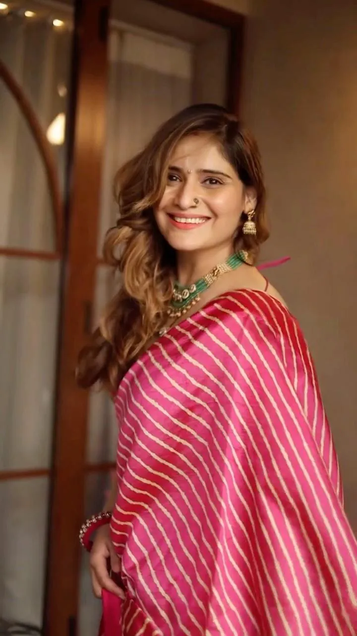 Arti Singh smiles softly in a pink ethnic outfit by the wall