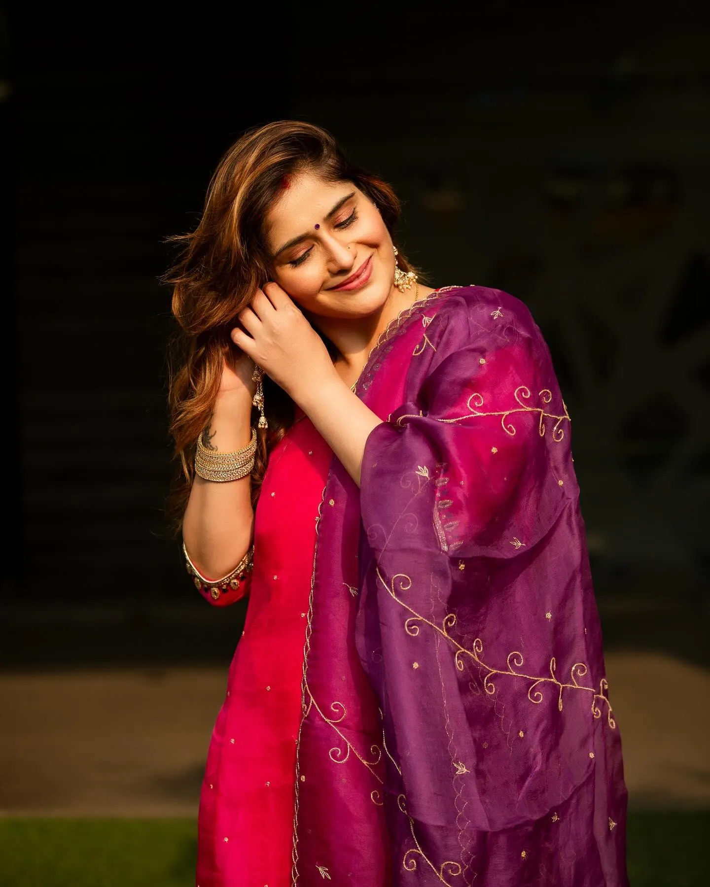 Arti Singh smiles sweetly in a pink outfit posing in garden