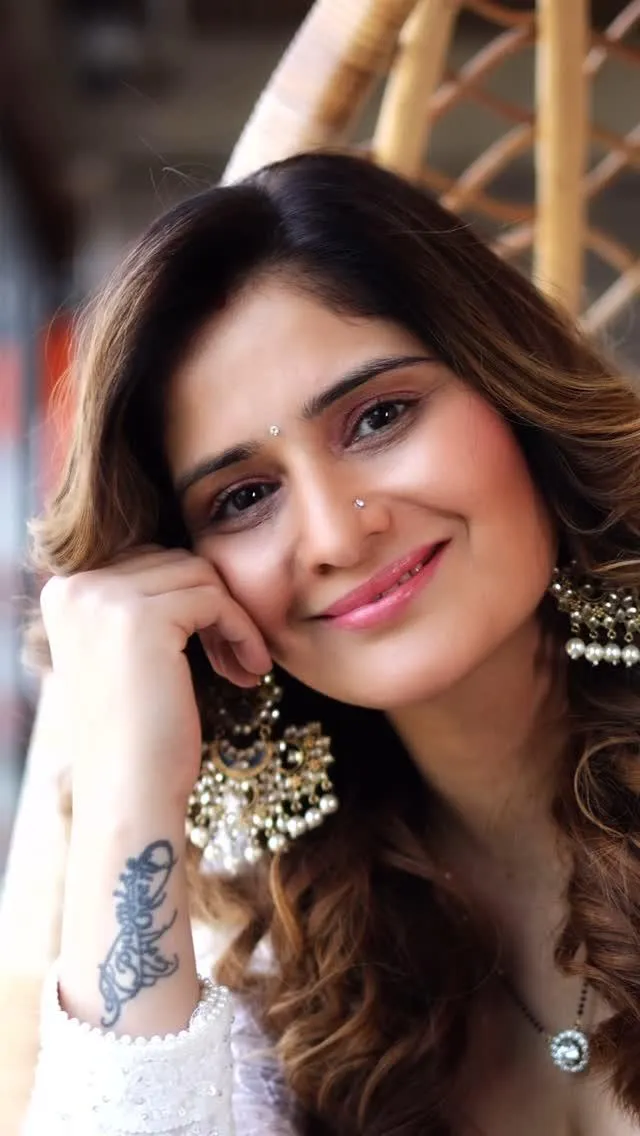 Arti Singh smiles warmly in a close up with soft curls image