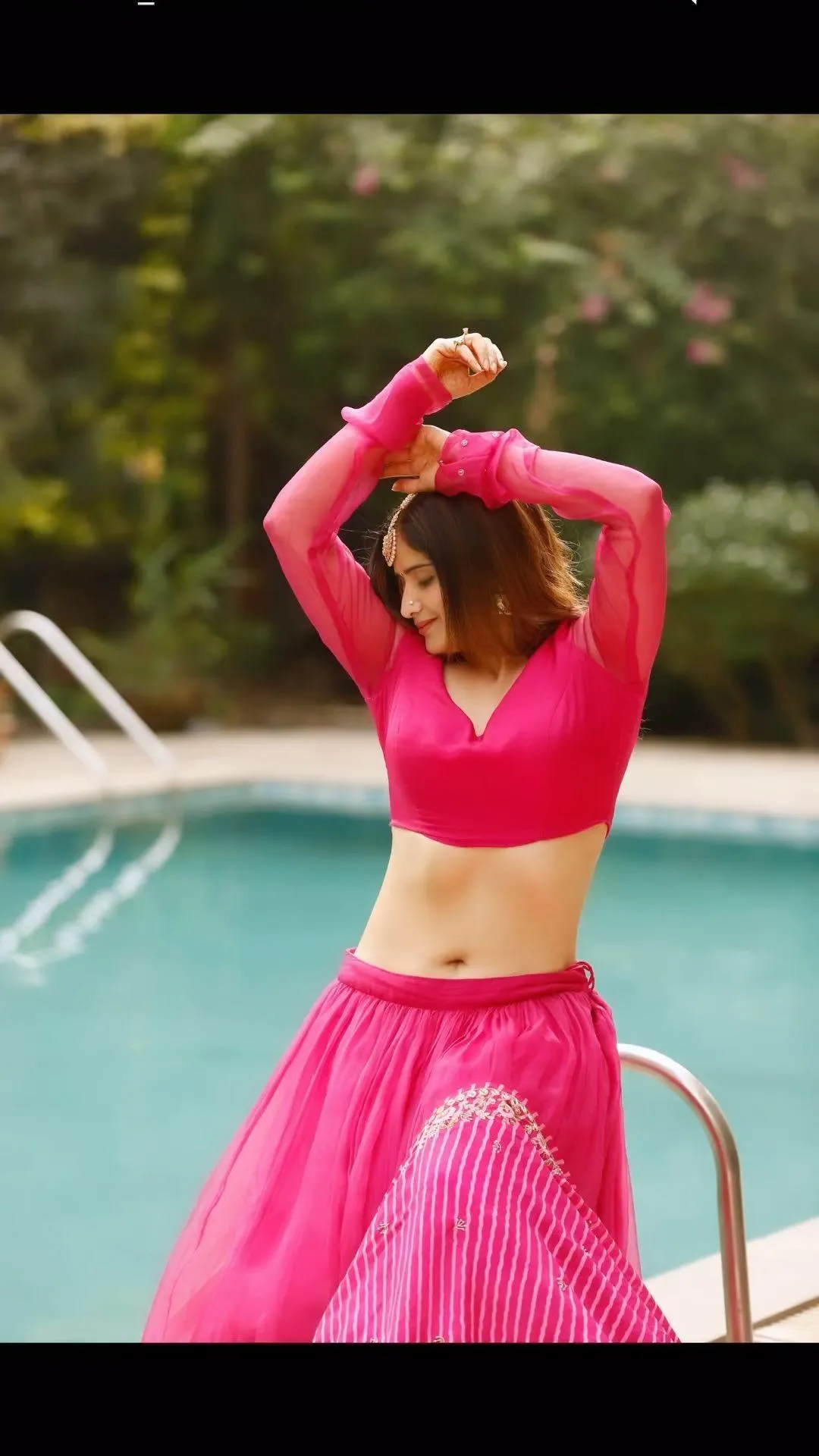Arti Singh strikes a bold pose in hot pink by the poolside