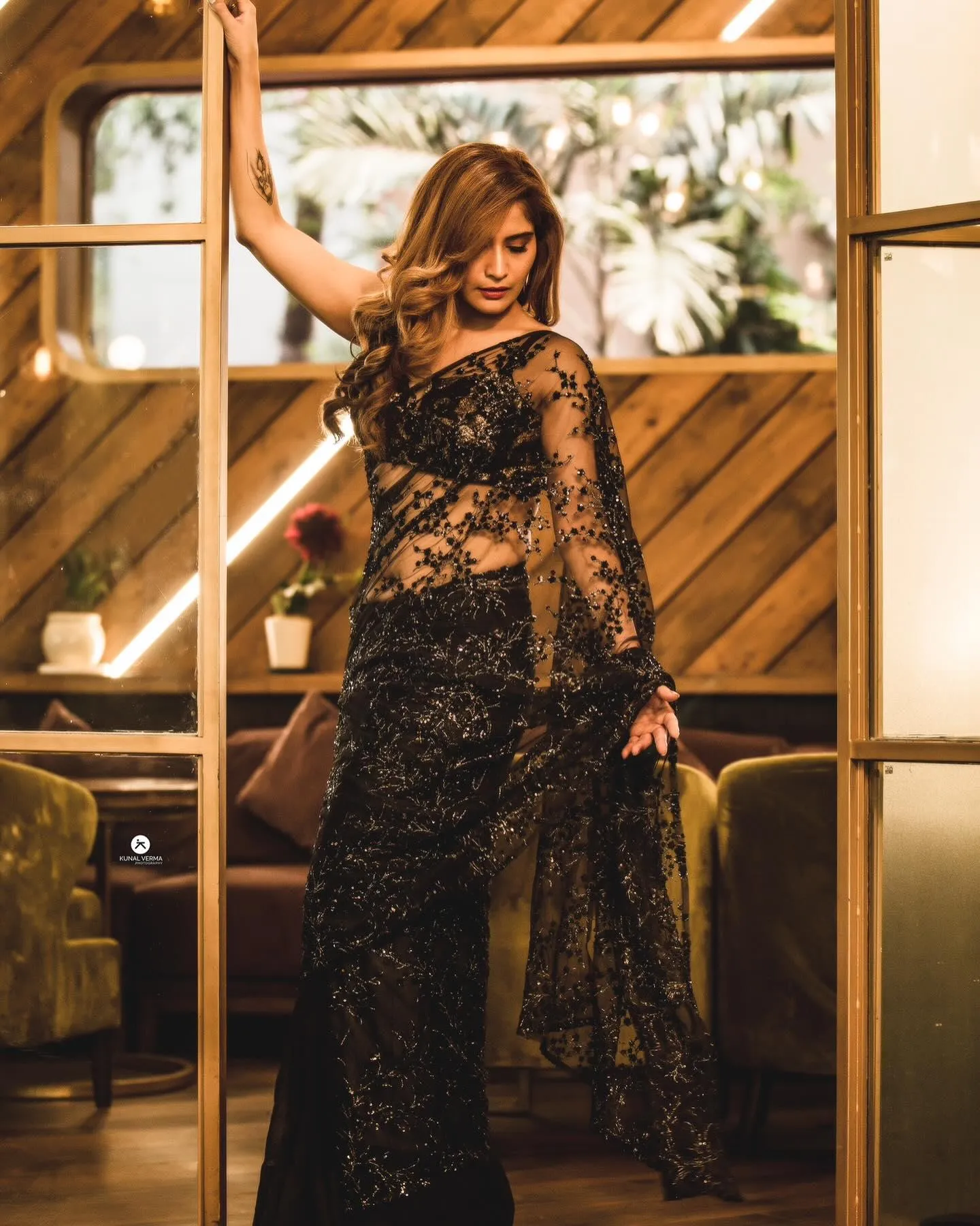 Arti Singh stuns in a sheer black saree with bold glam image