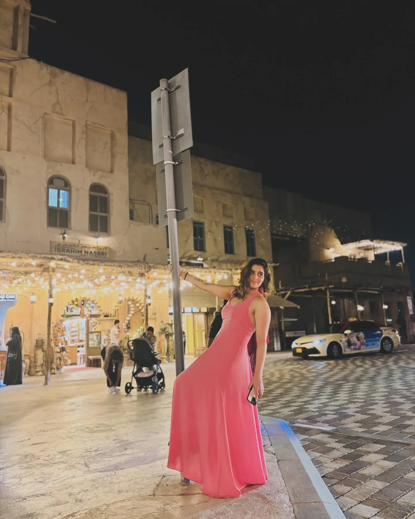Arti Singh walks gracefully through a scenic market street