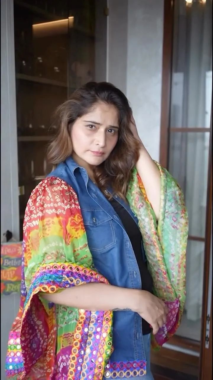 Arti Singh wraps herself in a colorful shawl with grace