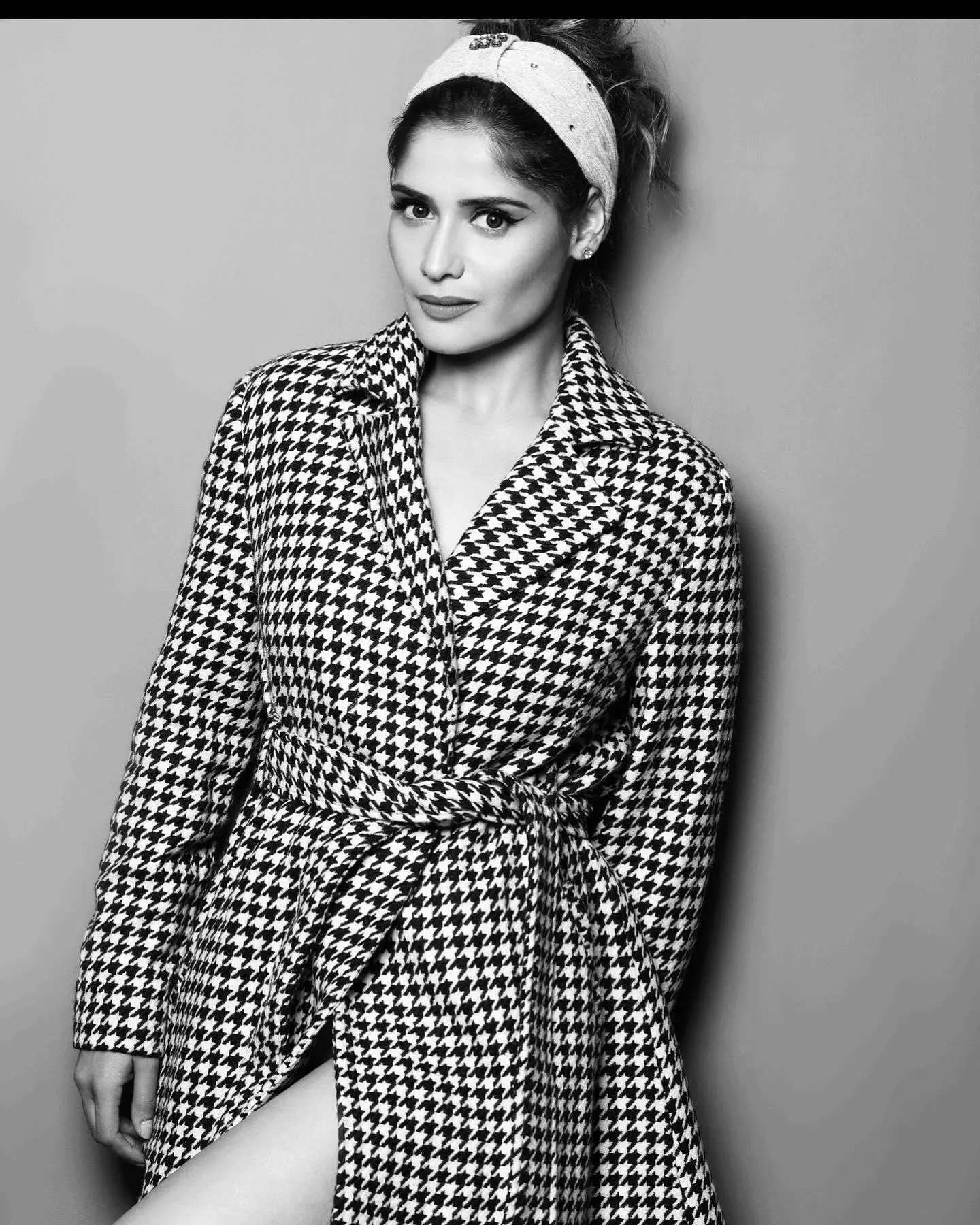Black and white photo of Arti Singh in a checkered blazer