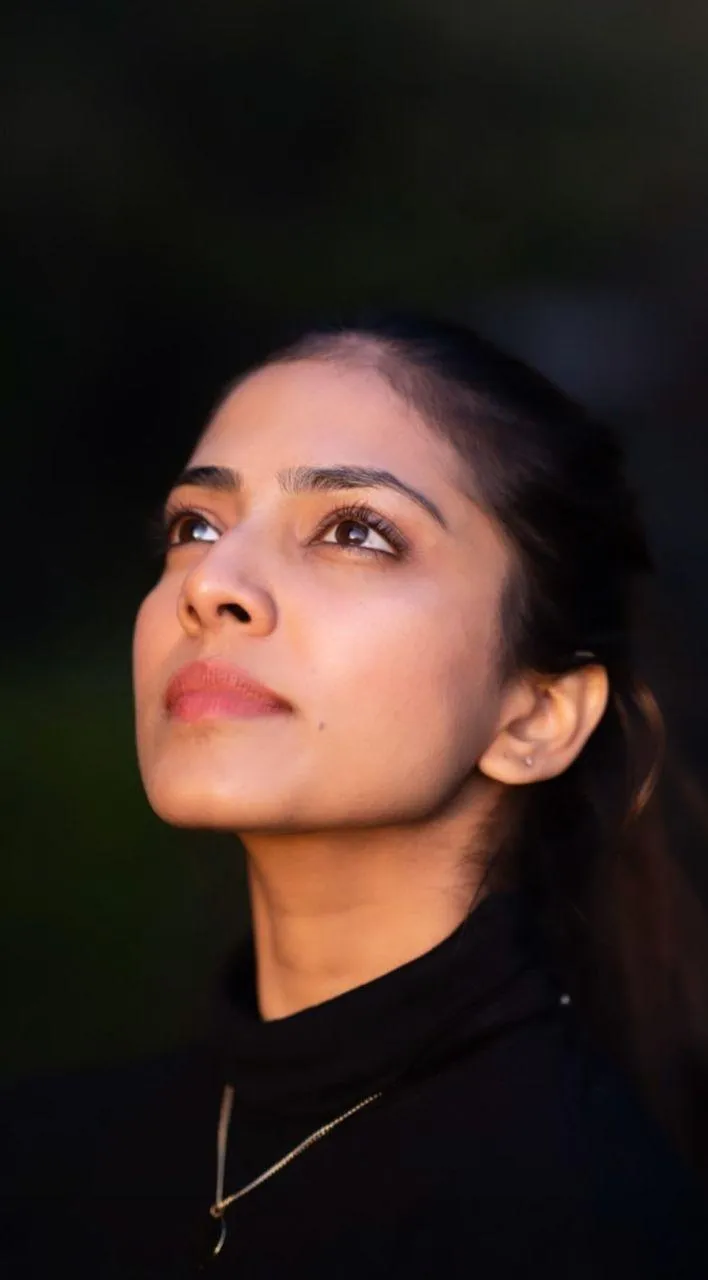 Attractive Malavika Mohanan in Black Dress Gazing Away