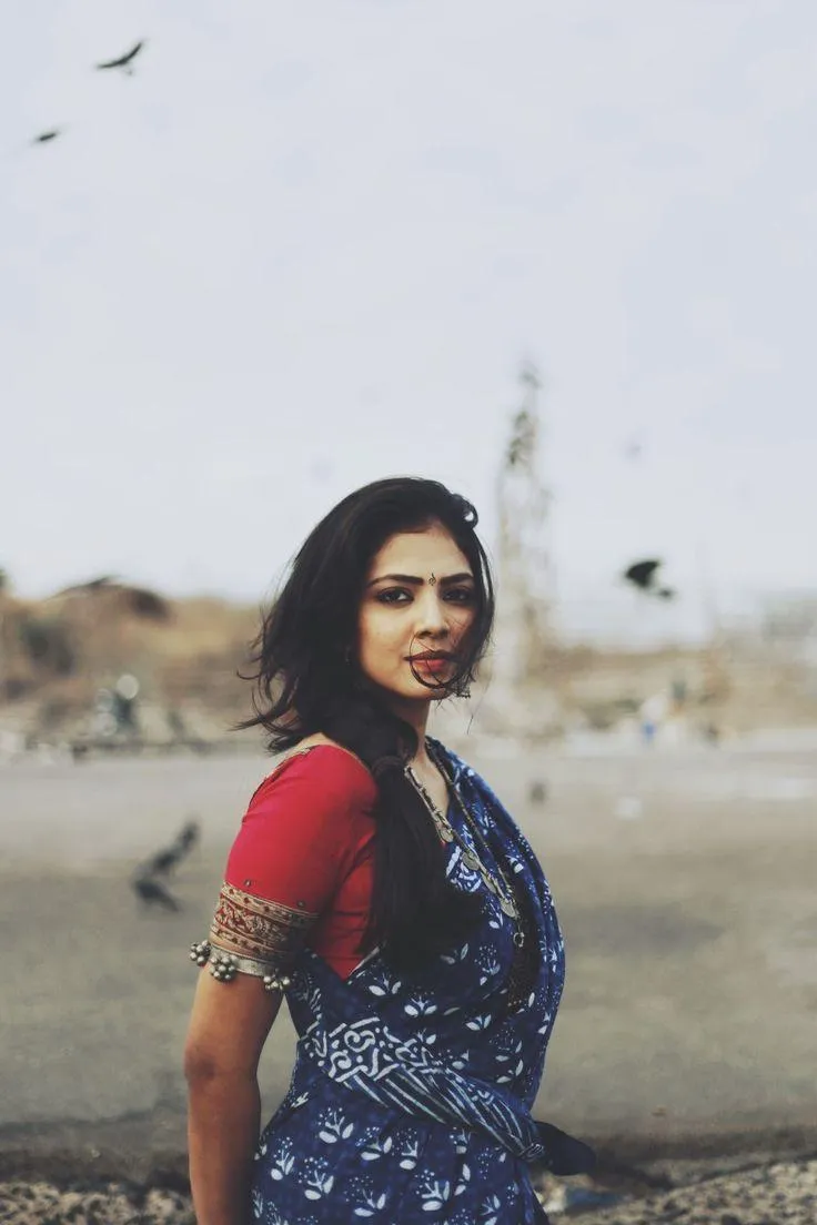 Attractive Malavika Mohanan in Blue Saree by the Beach Photo
