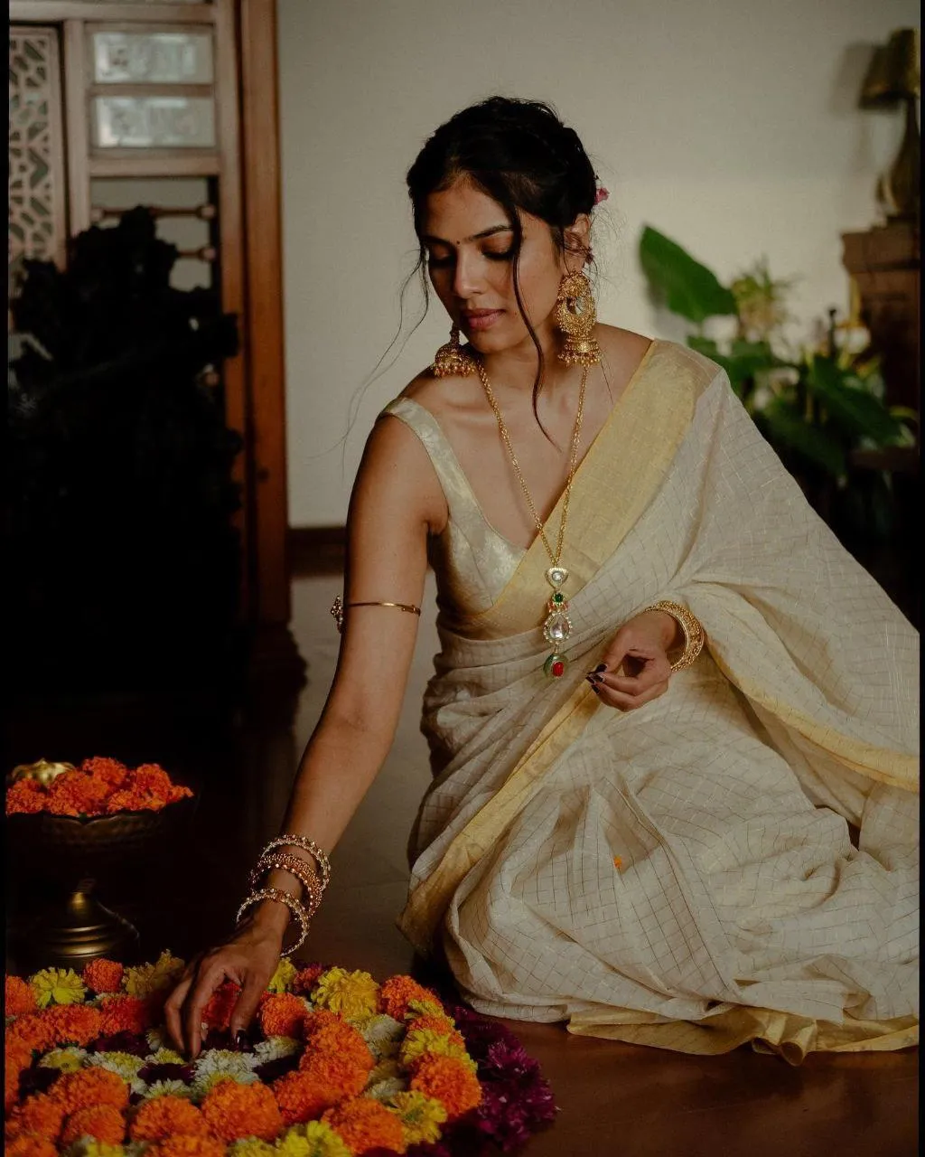 Attractive Malavika Mohanan in Cream Saree with Festive Pose