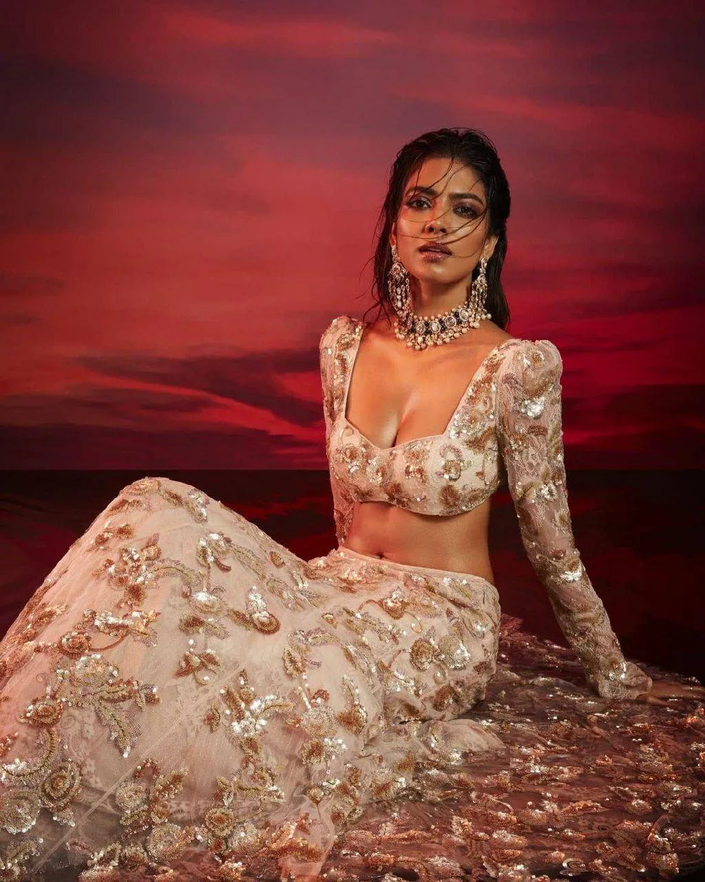 Attractive Malavika Mohanan in Floral Lehenga Seated Pose