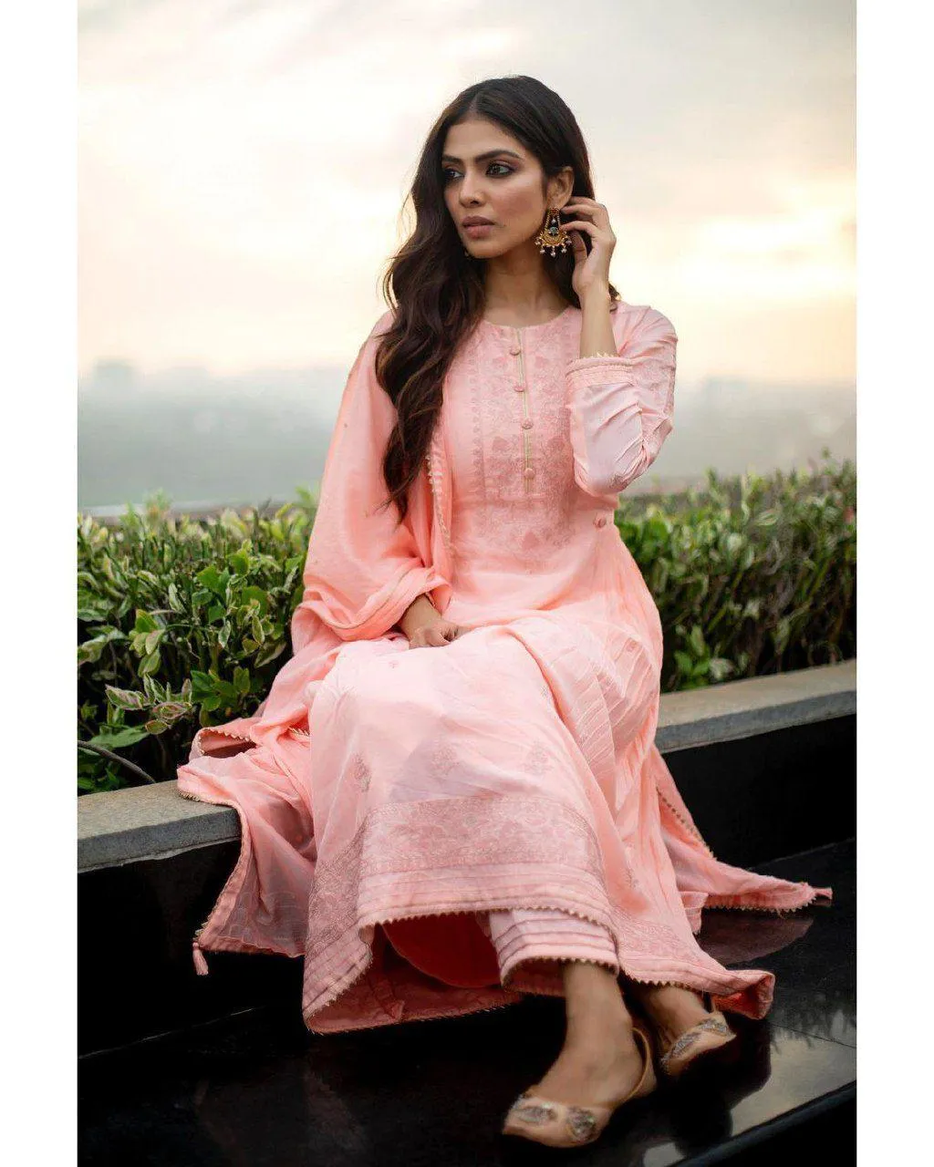 Attractive Malavika Mohanan in Pink Dress Outdoor Sitting