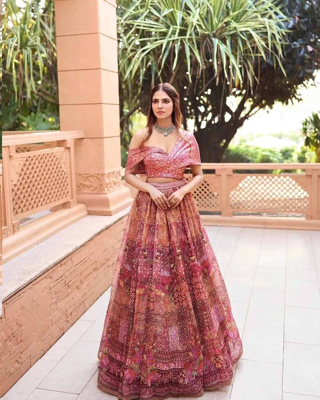 Attractive Malavika Mohanan in Pink Lehenga Outdoor Pose