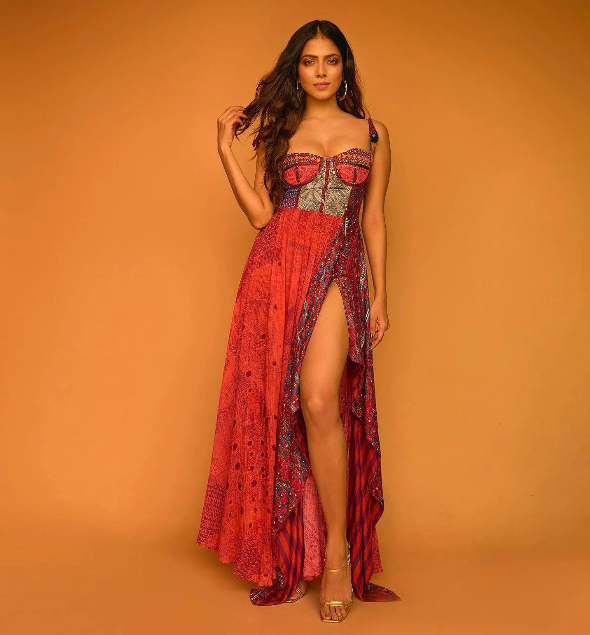 Attractive Malavika Mohanan in Red Gown Bold Standing Pose