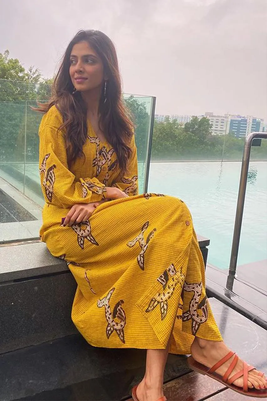 Attractive Malavika Mohanan in Yellow Saree Balcony Pose