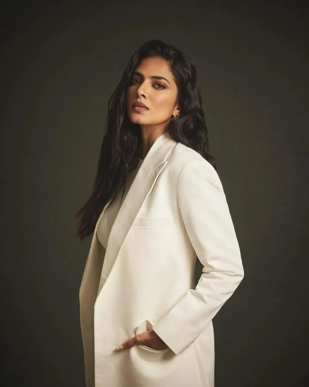 Attractive Malavika Mohanan Posing in Elegant White Dress