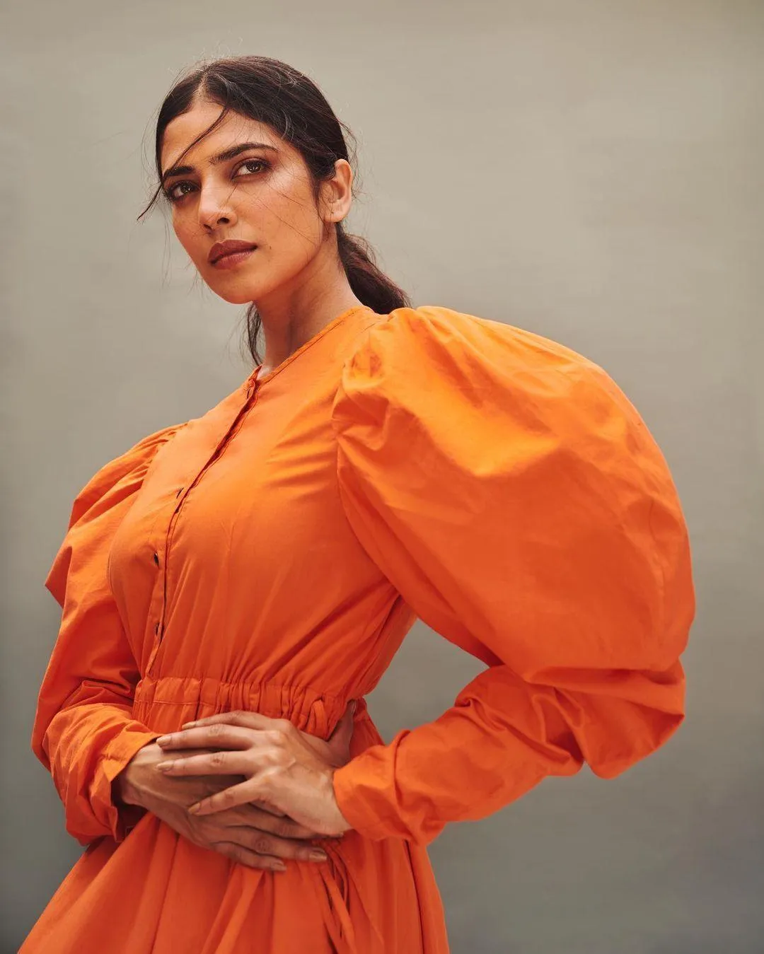Attractive Malavika Mohanan Wearing Bright Orange Outfit