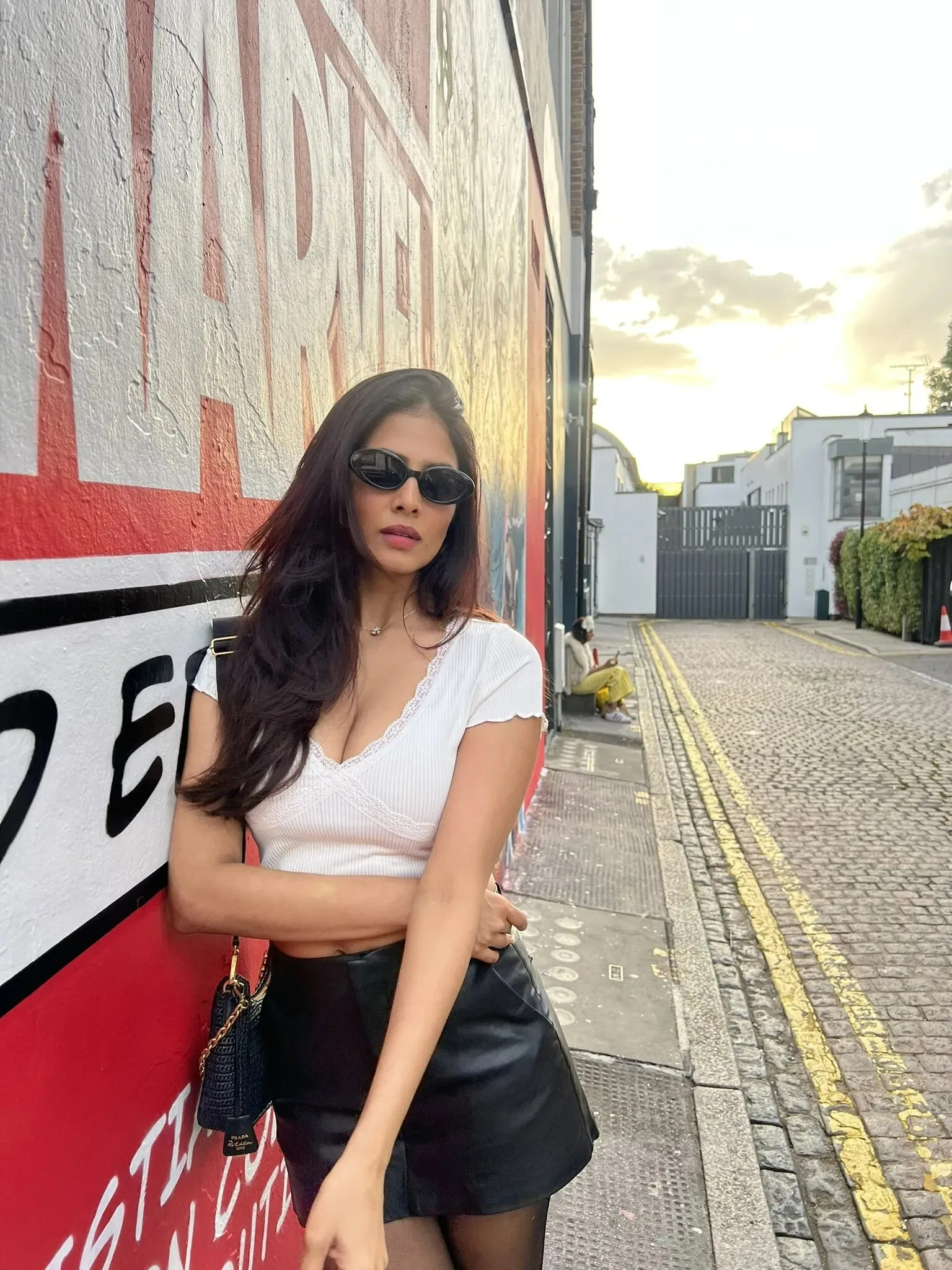 Attractive Malavika Mohanan Wearing White Top and Jeans
