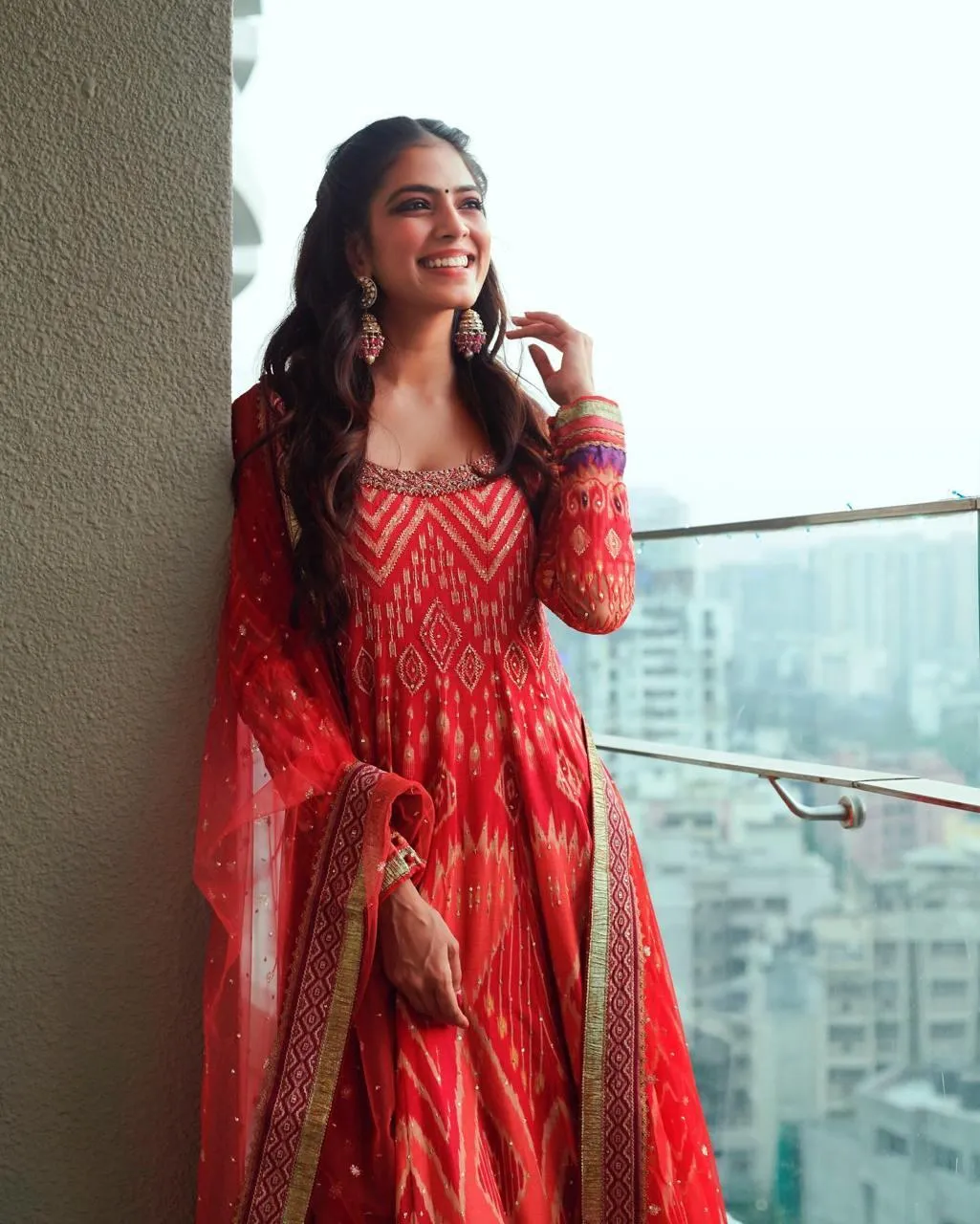 Beautiful Malavika Mohanan in Red Lehenga Balcony Posing