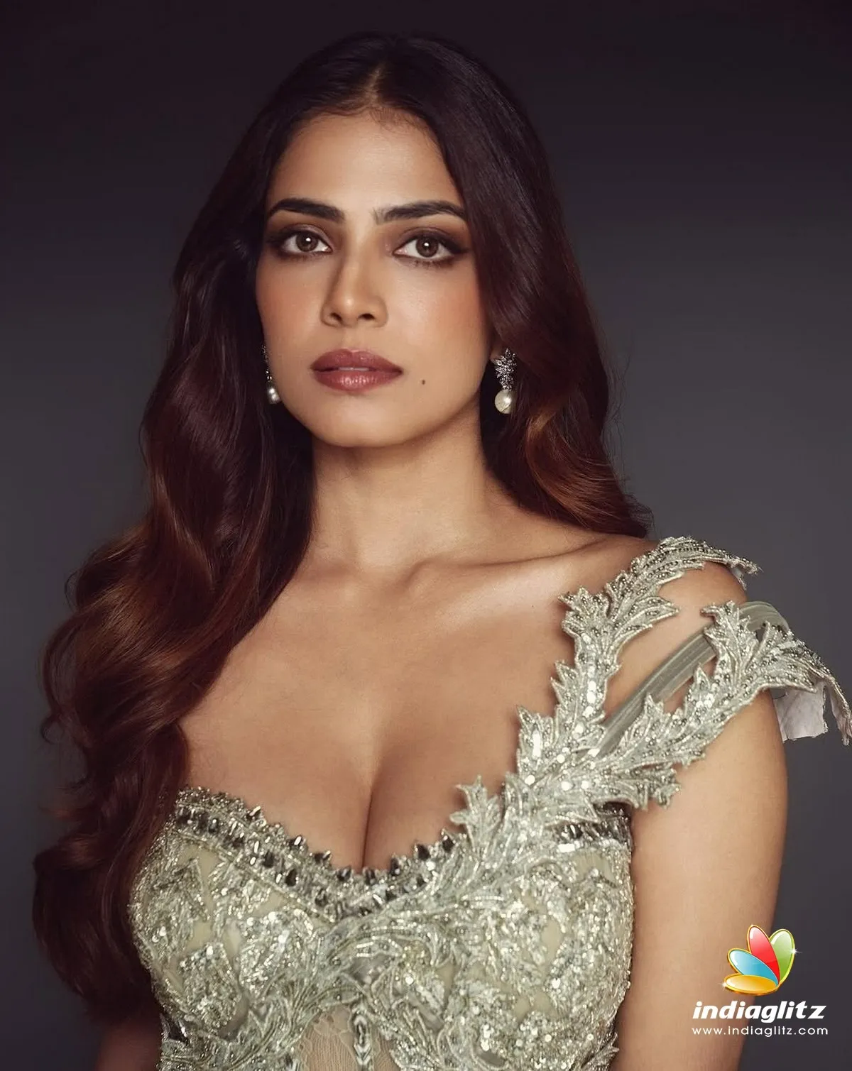 Beautiful Malavika Mohanan in Silver Dress Sitting Pose