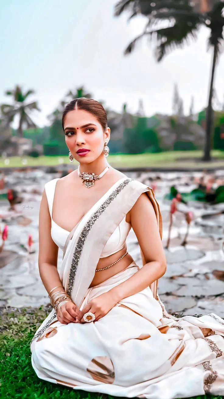 Beautiful Malavika Mohanan Sitting Outdoors in White Dress