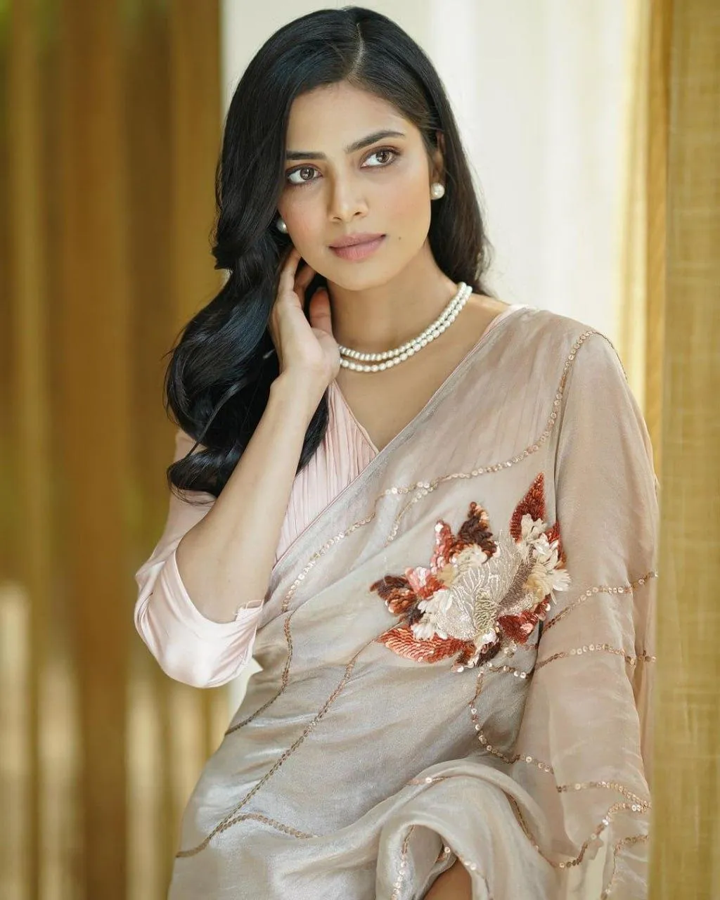 Charming Malavika Mohanan in Cream Saree Indoor Elegant