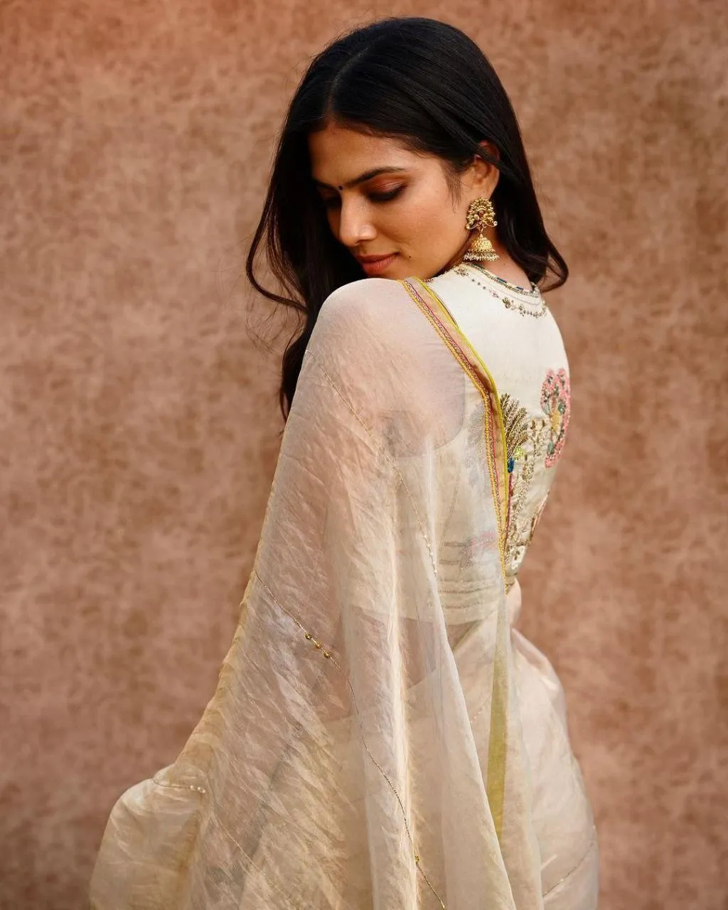 Charming Malavika Mohanan in Off White Saree Graceful Pose