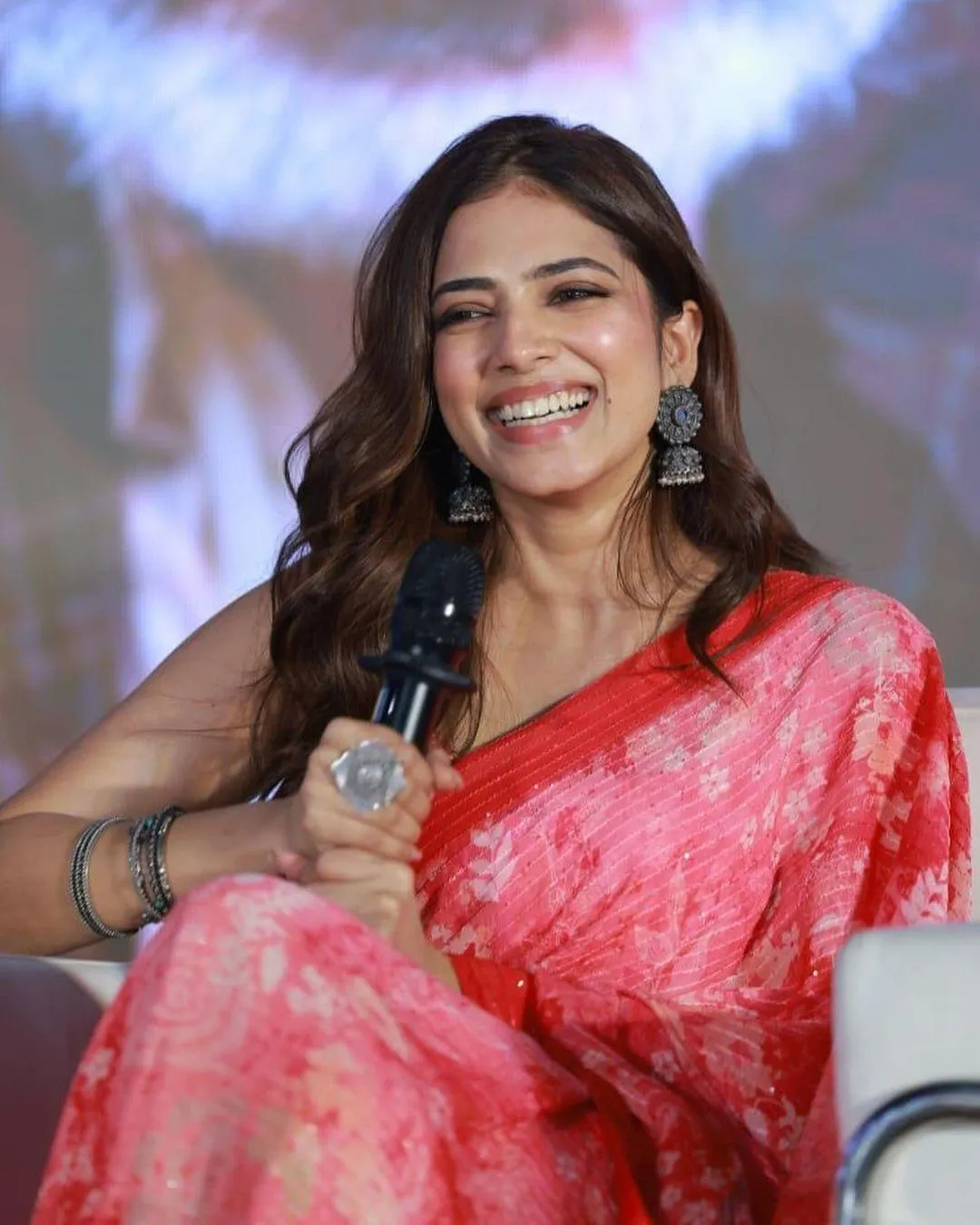 Charming Malavika Mohanan in Red Saree Smiling on the Stage