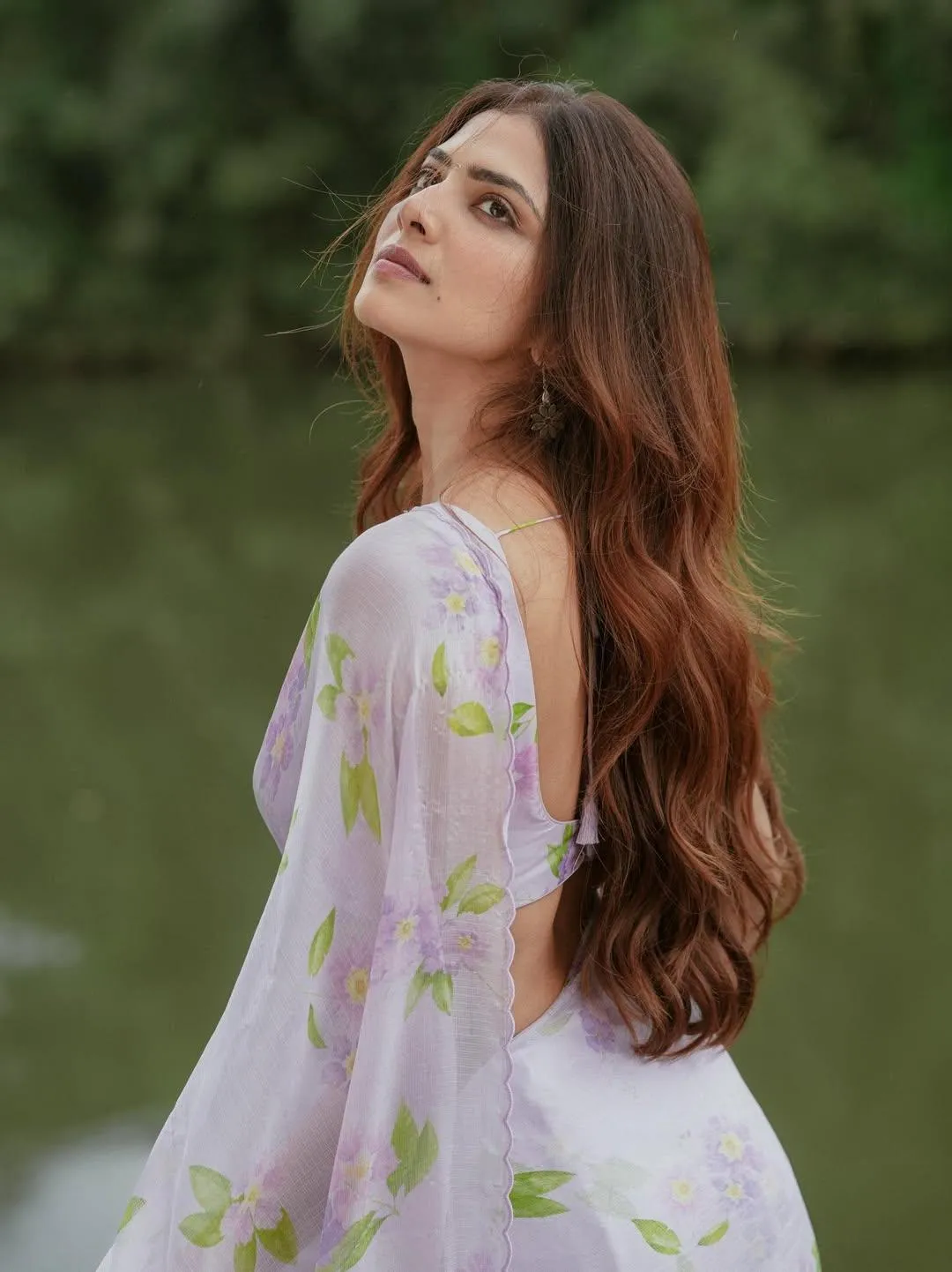 Charming Malavika Mohanan Posing Outdoors in White Dress