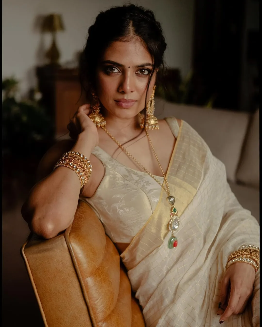 Charming Malavika Mohanan Seated in Modern Saree Portrait